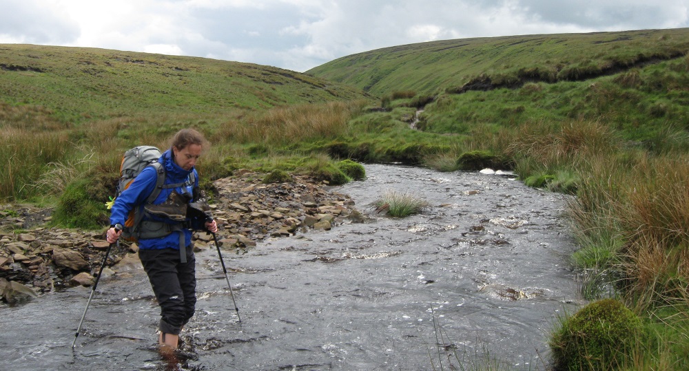 Mika enjoying very wet feet while keep her boots dry in a stream crossing in Dartmoor, England